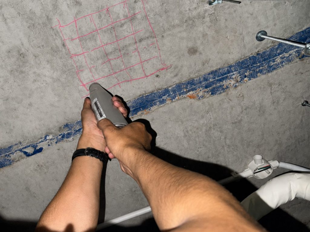 Inspecting the concrete slab after removing finishes