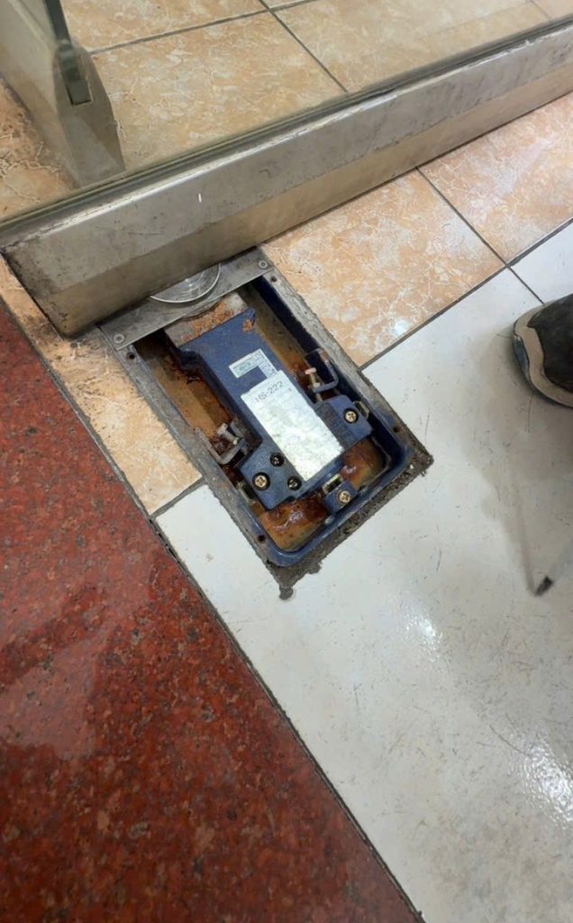Inspecting a glass door floor spring