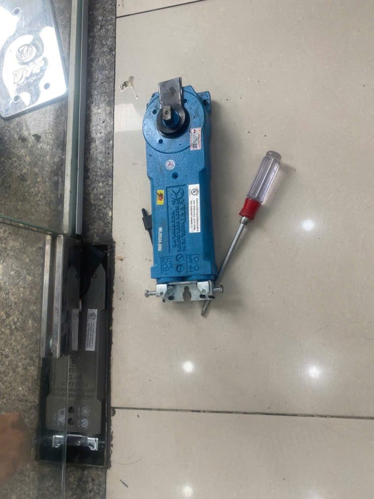 Replacing a glass door floor spring at a bank